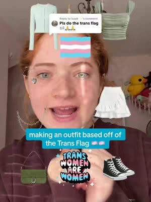 A selfie-style video cover with a young person in the center facing the camera. The person has fair skin, long red hair, and is smiling slightly with their mouth open. Overlaid on the image are various clothing items suggestive of a style transformation, the Trans flag and an overlay that says "making an outfit based off of the Trans Flag". A colorful icon for 'Trans women are women' is also on the image.