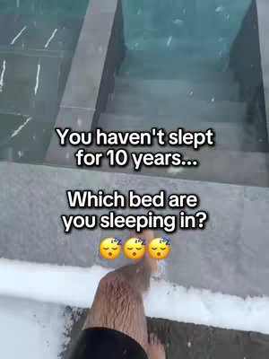 The image shows the lower half of a person's legs standing on some sort of wet surface, possibly stairs or a platform with a pool of water. The stairs lead in the background. Text is overlaid on the image. The image has a cold or wet feel based on the surrounding environment.
