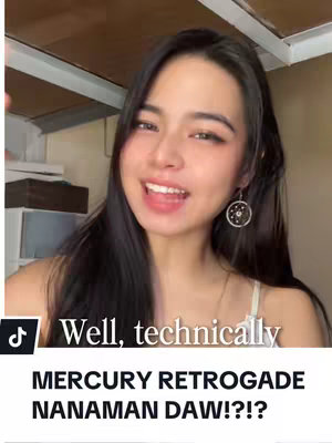 A young woman with long dark hair and a smiling expression is centered in the frame. She wears earrings and a white top. Text overlay is written across the bottom. The background is a room.