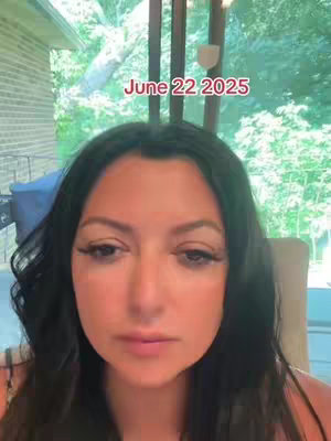A woman with black hair and long eyelashes is centered in the frame under a window with soft, diffused light. The text overlay reads "June 22 2025" in a red font.