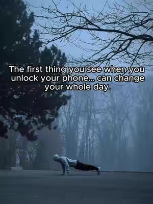 A person is doing push-ups on a road with trees and a misty background, the top has a text overlay that delivers a motivational message