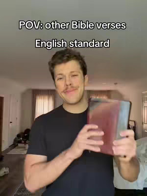 The cover image is a selfie-style video featuring a man in a black t-shirt holding a red Bible. The background shows the interior of a house, with a focus on the man's upper body, which he is holding the Bible. Overlay text at the top says "POV: other Bible verses English standard."