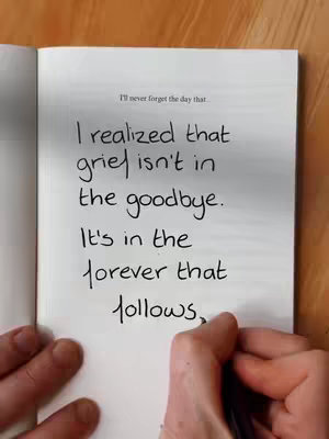 The cover image shows an open book with a handwritten quote about grief. A hand is visible writing in the book. The background is a plain, light-colored surface.