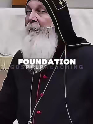 A medium shot of an older man, with a white beard and a black robe. His facial features are visible with visible wrinkles. The background is blurred, and the text overlay displays the words 'FOUNDATION' and 'GOSPELPREACHING'. The smoke from mouth appears in the middle of the image.