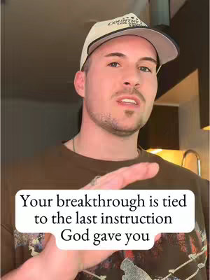 A man in a baseball cap is facing the camera. A text overlay is visible at the bottom portion of the screen.