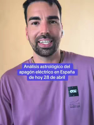 A man is centered in the frame, appearing to be speaking directly to the camera. He's wearing a purple t-shirt and has short dark hair and a beard. A colored rectangle is overlaid, containing text. The background is a plain, light-yellow wall.