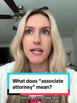 A young woman with blonde hair is centered in the frame, looking directly at the camera and speaking. Behind her is a ceiling fan, a wall, and a glimpse of the room's contents. Overlayed on the image is a blue and white box with text that poses a question.