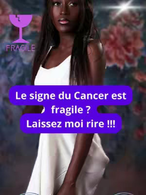 A woman with dark skin and long black hair is centered in the image. She wears a white dress, and a purple speech bubble with white text is superimposed. A “fragile” graphic appears in the upper left. The background is a blurred mix of colors.