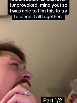 A close-up shot of a man's face. He has dark hair, a mustache, and is wearing a ring on his left hand. The background is a neutral, slightly blurred wall color. The video has a text overlay indicating "Part 1/2".