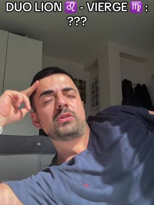 A man with dark hair and a beard is shown in a selfie-style shot. He rests his head on his hand, with his eyes closed. Text overlays at the top read 'DUO LION ♌ - VIERGE ♍ : ???'. The background is a softly lit room with minimal decor, including a white wardrobe and wall.