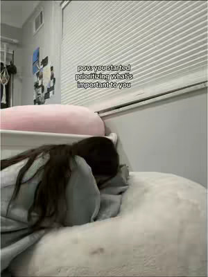 The cover image shows a woman lying in bed, mostly obscured from view, with dark hair cascading over a pillow. The composition focuses on her upper body and the surrounding pillows and bed linens, creating a sense of intimacy and privacy. The background includes a light-colored wall and window treatments.