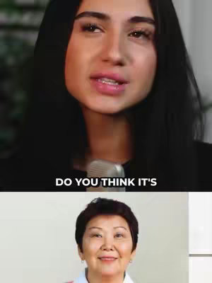 The cover image shows a split screen. The top half features a close-up of a woman’s face, likely the creator, with a microphone in front of her. She has dark hair and is looking towards the viewer, with a question mark written on the screen. The bottom half has an image of an older Asian woman smiling.