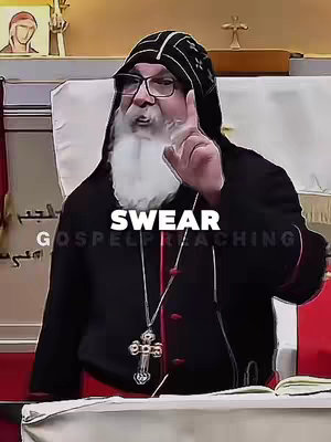 The image shows a religious figure in a traditional outfit. The figure is older with a full white beard and glasses, and is giving a pointed or accusatory gesture with their right index finger. Text appears overlain providing emphasis