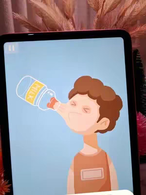 An illustration, inside a tablet screen, depicts a cartoon figure whose facial features are distorted as if drinking from a milk bottle. The background of the image is a light blue gradient, and behind the tablet appears a pinkish-brown floral decoration.