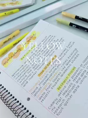 The image shows a workspace with a notebook and different colored markers giving the appearance the notes are from a student's study session.