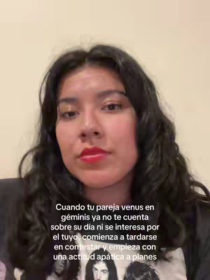 A woman with dark hair and red lipstick looks directly at the camera. Overlayed text appears below her with a light background.
