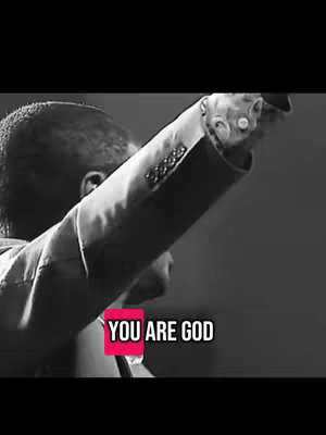 A black and white image with a person raising their arm to the right. Text on a pink block reads, "YOU ARE GOD."