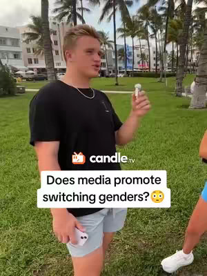 The cover image shows a young man with light hair and a black t-shirt standing outdoors in front of a grassy area and palm trees. He is holding a small microphone and a white phone. A text overlay asks a question about media's influence on gender switching. Another person's legs and feet are seen to the right.