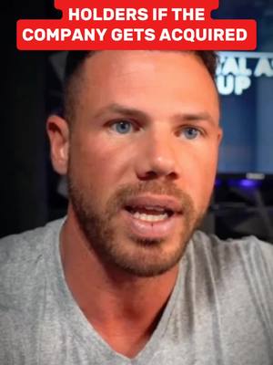 A man with short brown hair and a trimmed beard is centered in the frame, looking directly at the viewer. He's wearing a plain gray t-shirt, and his expression is one of mild to moderate interest. Above him, there's a red rectangular bar with white text.