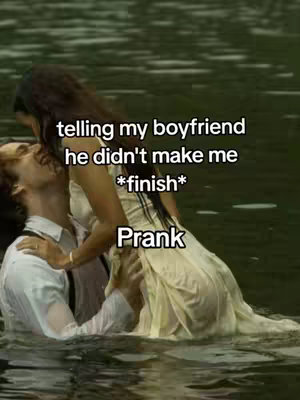 A couple stands in water and embraces, with the woman appearing to be lifted by the man. The woman wears a light-colored dress. Text overlays read, "telling my boyfriend, he didn't make me *finish*". The overall style suggests a romantic-comedy prank.