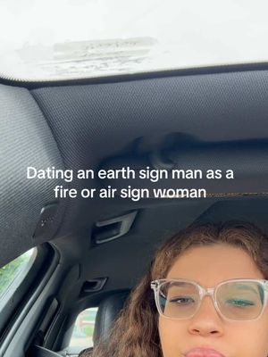 The cover image shows a selfie taken from inside a car. The creator, a person with curly brown hair and clear-framed glasses, fills the lower portion of the frame. Above them, text overlays are visible against the car's interior. The background reveals a portion of the vehicle's ceiling and windshield, with some daylight visible. The overall composition is casual.