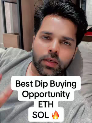 A selfie-style video cover. A man is in the foreground, looking at the camera with a slightly concerned expression. Behind him is what appears to be a room with wood paneling on the left side and a simple white wall on the right. overlayed on the foreground is a graphic with the headline "Best Dip Buying Opportunity" followed by the crypto symbols ETH and SOL with a flame emoji. He is wearing a gray t-shirt.