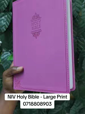 The cover image shows a large, closed, purple leather-bound Bible held in a dark-skinned hand. The book has a gold-embossed design on the cover and white edges. A white rectangle at the bottom features the text 'NIV Holy Bible - Large Print' and a phone number.