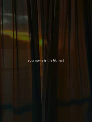 The image shows a view through partially visible curtains, with a sunset or sunrise in the background. A text overlay is visible near the bottom.