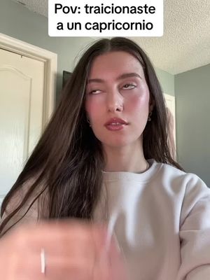 A young woman with long brown hair and a white sweater is looking up and to the side with her eyes. Above her is a text overlay.