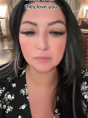 A close-up shot features a woman with dark hair and large hoop earrings. She has thick eyelashes and full lips. The background is blurred, partly showing an ornate wooden furniture. A text overlay at the top reads, "June 7 2023 they love you".