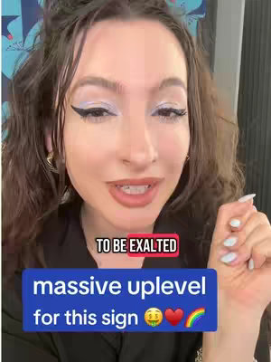 The cover image shows a woman with long brown hair, dark eye makeup, and a light-colored eyeshadow looking at the camera. She is positioned in front of a wall with a patterned blue design. There are overlaying text boxes stating 'TO BE EXALTED' in a red box and 'massive uplevel for this sign' with money, heart, and rainbow emojis.