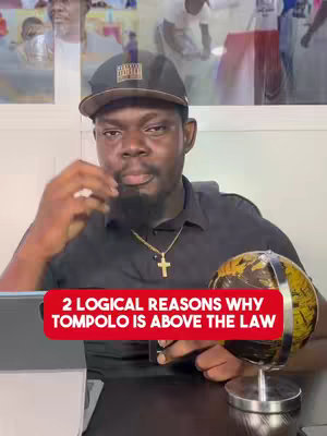 A man in a black shirt and a black cap is the central figure. A globe rests on a table in front of him. Overlaid on the image is a red rectangle containing white text.