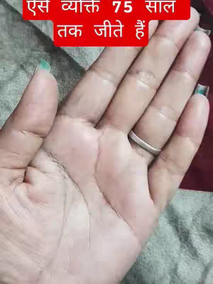 The image shows a close-up of a hand, with visible palm lines and a silver ring on a finger. The background is a soft, textured fabric in shades of gray and maroon. Overlayed on the image is a red rectangular banner containing Hindi text.