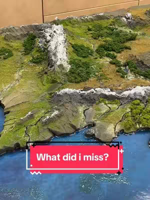 The cover image showcases a detailed miniature model of a mountainous terrain with a body of water. The model is colored with shades of green, brown, white, and blue. A red rectangle with white text that says "What did i miss?" overlays the scene.