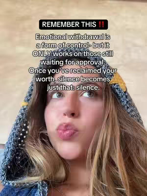 A close-up shot of a young woman with blonde hair, wearing a hooded garment. She has light skin and is looking directly at the camera with a slight pout. Above her and behind her is text in a black rectangle.