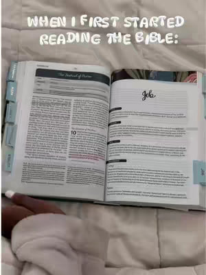 An open Bible lies on a white bedspread. The left page has text and tabs, partially highlighted in red, and is labeled with a light blue tab. The right page has handwritten text in cursive above some lines of text and is labeled with a light blue tab. The creator's arm is visible underneath the pages. Above the bible in white text is the hook.