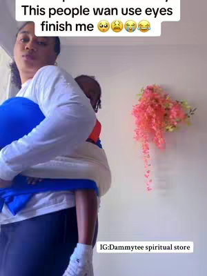 A woman is holding a child while posing for the camera. A hook message is displayed above the woman's head in the top left corner.