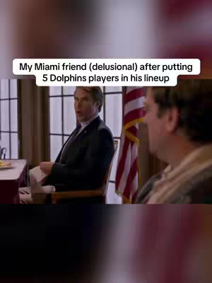 The image shows a split-screen view of two men in a room discussing. The left side features a man in a suit sitting in a chair, possibly in an office setting, while the right side shows the other man.There is an American flag in the background.