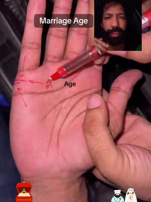 A hand is held out, palm facing the viewer, with arrows and numbers drawn on it. A face, likely the creator's, is displayed in a small inset in the top right. The overall tone suggests a palmistry reading, possibly about marriage.