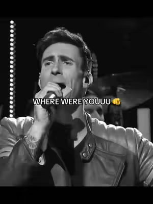 Black and white image of a man with short hair singing with a microphone in front of his mouth. Text overlayed on the image states "WHERE WERE YOUUU".