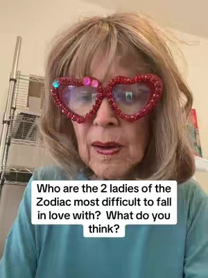 A close-up shot of an older woman wearing large, heart-shaped, sparkly red glasses. She has light-colored hair and is wearing a blue top. A text box with white text is overlaid on the image.