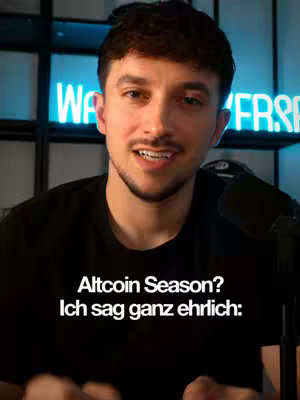 A man with a short beard and dark hair is centered in the frame, looking straight at the camera. The background is softly illuminated with a neon sign that says 'WA VERSE'. Text overlayed across the bottom indicates the topics discussed, suggesting a video related to finance and cryptocurrency. The man is wearing a black t-shirt with a text overlay that says 'Altcoin Season? Ich sag ganz ehrlich:'.
