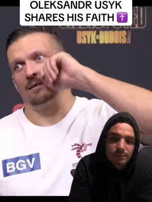 The cover image features Oleksandr Usyk, a boxer, with text overlayed. Usyk is looking down with an upward gaze, an expression suggestive of contemplation or prayer. A second person, wearing a black hoodie, is partially visible in the lower right corner of the video frame. The background suggests an arena for a boxing match with branding of 'USYK-DUBOIS'. The overall impression is a blend of faith and athleticism.