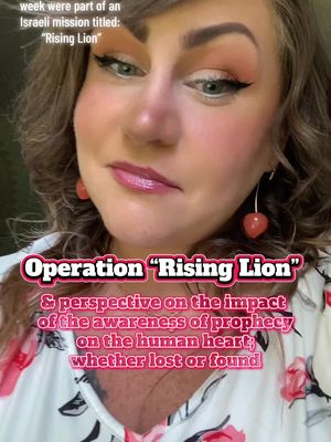 A selfie-style shot featuring a woman with light skin and reddish-brown hair. She has visible makeup, including pink eyeshadow and blush. The overall composition is a close-up, focusing on her face and upper torso, with text overlays adding context; the background is blurred.