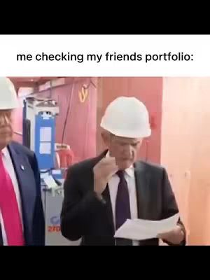 An image featuring two men in suits and hard hats. One man is holding a document and appears to be examining it with a concerned look, while the other man is in the left background. The setting appears to be an industrial or architectural environment.