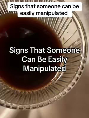 The cover image shows a close up shot of a transparent glass bowl filled with a dark liquid, with superimposed text overlay which says 'Signs that someone can be easily manipulated'. The liquid in the glass appears to have a dark brown look and a blurred focus.