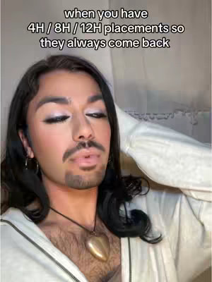 The cover image shows a person with long black hair and a trimmed mustache and beard. They are wearing a white zip-up, and a large heart-shaped pendant necklace. Text overlays at the top state, 'when you have 4H / 8H / 12H placements so they always come back'. The person is looking up with a slight expression.