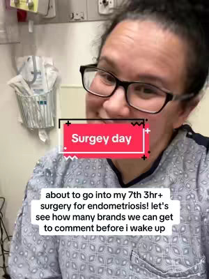 A selfie-style shot taken in what appears to be a hospital room. The main subject is a woman with glasses, wearing a hospital gown. Overlaid on the image is a pink and white rectangular box with the words "Surgey day", and the bottom text reads "about to go into my 7th 3hr+ surgery for endometriosis! let's see how many brands we can get to comment before i wake up."