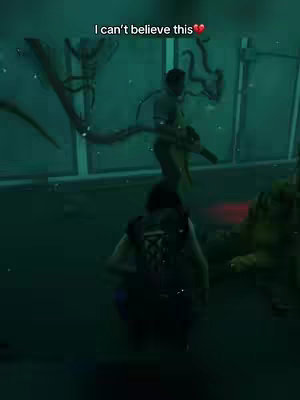The image appears to be a scene from a video game, with low visibility due to a green-tinted environment. Two figures are visible, one crouched with their back to the viewer. Text in the top third of the video indicates that the creator is surprised.