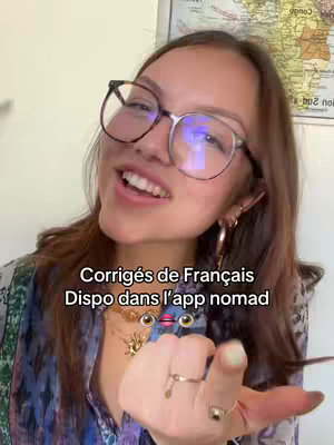 A young woman with glasses smiles and speaks to the camera, with text overlays. She has brown hair and is wearing earrings and necklaces; in the background, a blurred map is visible.